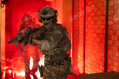Preview: Soldier in full US MARSOC armed with assault rifle run through the abandoned building. Military