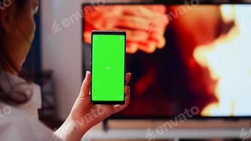 Preview: Close up of woman vertically holding green screen