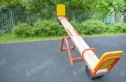 Preview: Balancing swing in the form of a wooden board on an empty outdoor playground, children's play area