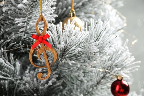 Preview: Fir tree with wooden treble clef and decor, closeup view. Christmas music