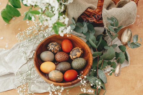 Preview: Modern Easter eggs in wooden bowl with spring flowers and eucalyptus on rustic table