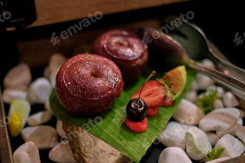 Preview: Stuffed zucchini and tomatoes rest on a stone slab; a rustic yet refined setup. The focus on organic