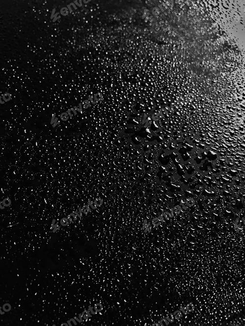 Preview: Vertical grey scale shot of water drops on a black table