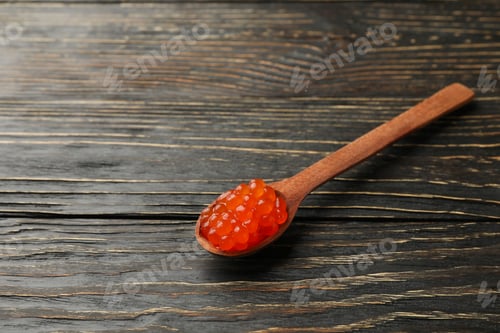Preview: Spoon with red caviar on wooden background, space for text