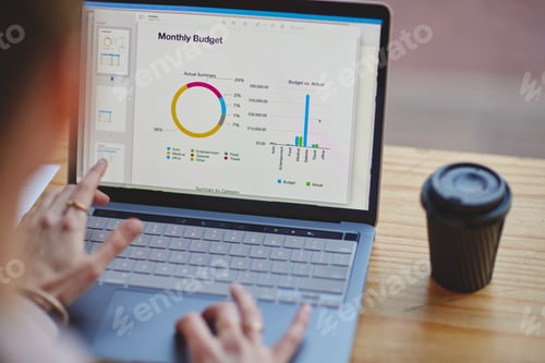 Preview: High angle shot of an unrecognizable businesswoman working on a laptop at her desk in the office
