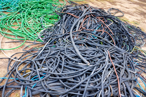 Preview: Outer casings of pvc electrical cables, abandoned and discarded, ready for recycling.