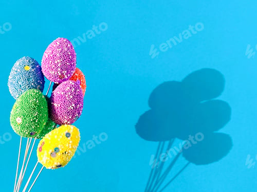 Preview: Multicolored Easter eggs on blue background - a nice holiday gift.
