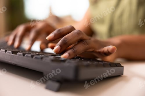 Preview: Black female hands typing on computer keyboard