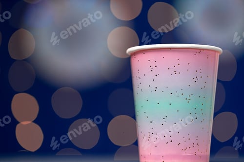 Preview: Pink disposable cup on blue bokeh background