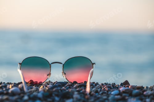 Preview: Colorful bright sunglasses on the background of the sea, concept summer vacation at the sea with