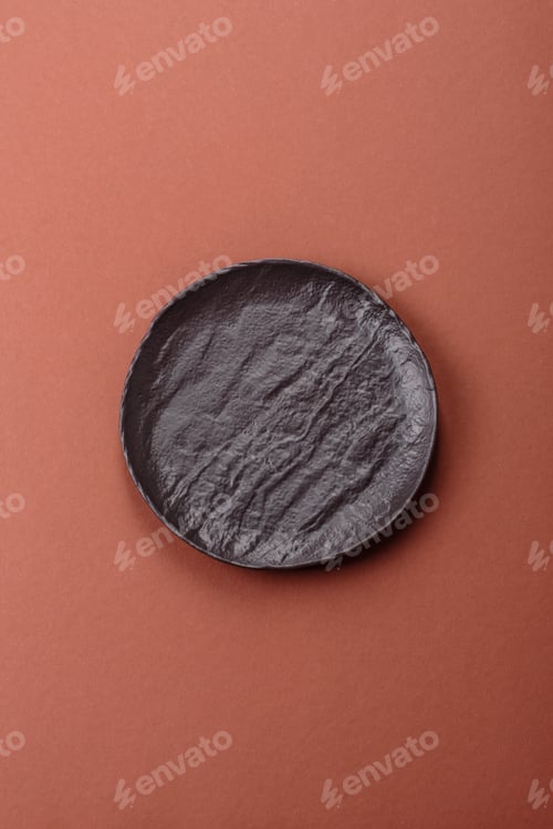 Preview: Empty ceramic plate on a monochrome brown background