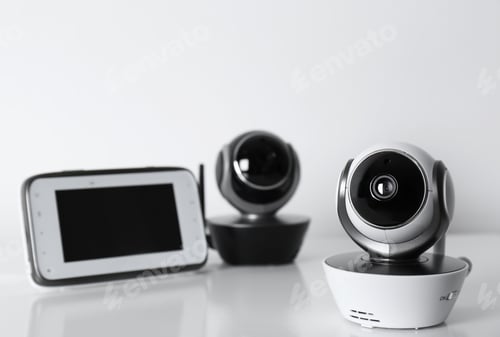 Preview: Modern CCTV security cameras and monitor on white background