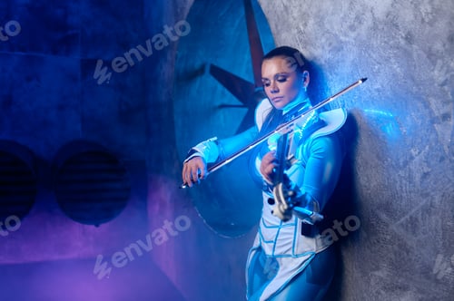 Preview: Side view portrait of beautiful fashion woman violinist