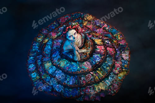 Preview: Latina woman dressed as a Mexican Catrina, with bold skull makeup