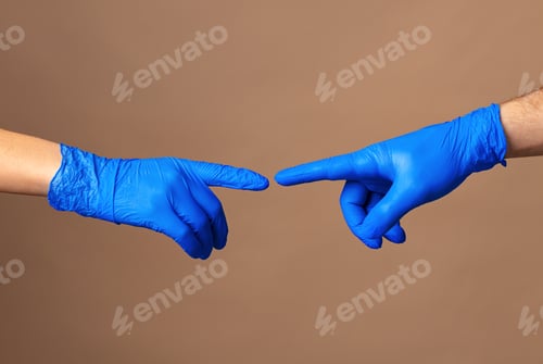 Preview: Male and female hands in medical gloves stretch to each other. Help concept.