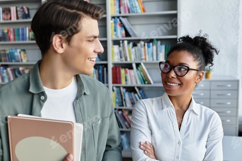 Preview: A dedicated teacher engages with her student in a vibrant library setting during a learning session