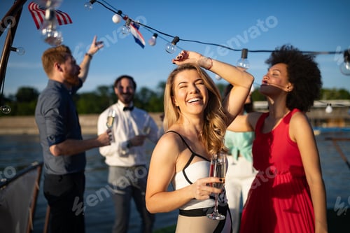 Preview: Group of happy friends drinking champagne and celebrating New Year