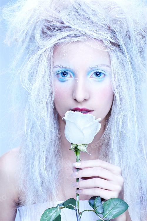 Preview: Close-Up Portrait Of Beautiful Blonde Frozen Fairy Nymph Girl With White Rose