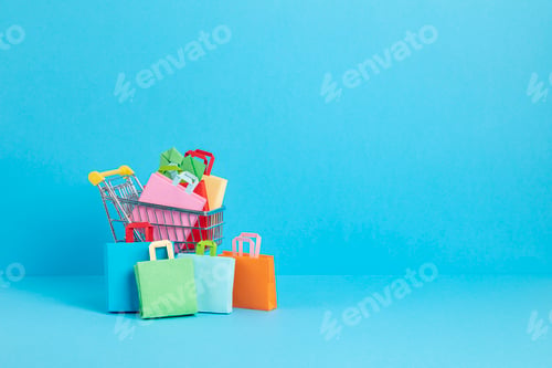 Preview: Shopping trolley full of paper bags. Sesonal sale, online deals, discounts, promotion, shopping
