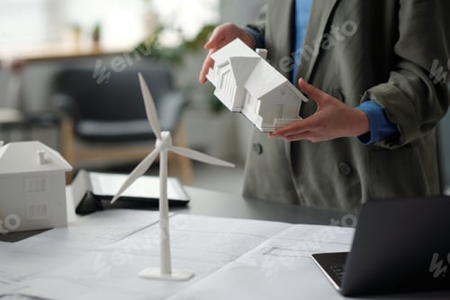 Preview: Model of house held by young architect
