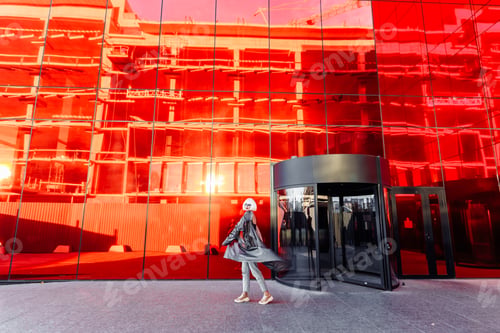 Preview: Futuristic style. Woman with glasses and near a red futuristic building.
