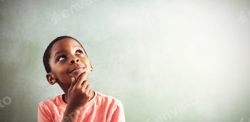 Preview: Thoughtful boy against greenboard
