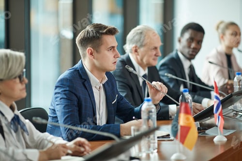 Preview: Young businessman speaking at conference