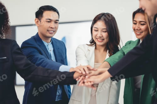 Preview: Young Asian business people shaking hands to agree to work towards the same goal and work together