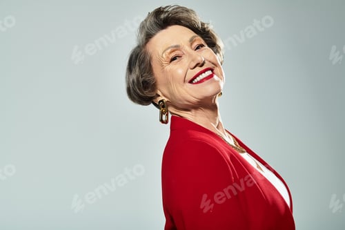 Preview: Mature woman showcases timeless beauty in stylish attire, radiating elegance and charm.