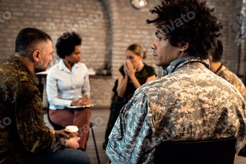 Preview: Group of diverse veterans talking during PTSD support group.