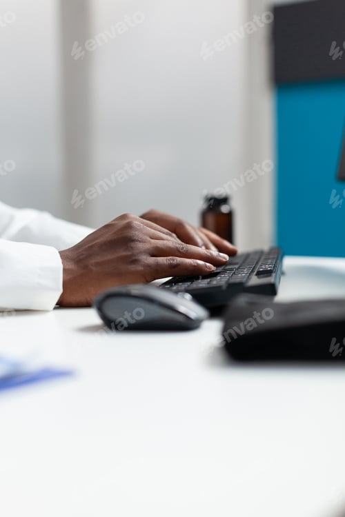 Preview: Closeup of african american therapist doctor typing patient healthcare treatment
