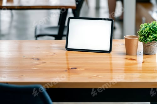 Preview: Mockup blank screen digital table on wooden table in co-workspace.