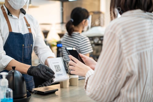 Preview: Close up of customer make easy contactless, scanning QR code to pay for drink at cafe