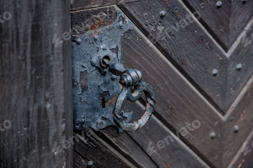 Preview: old black metal knob of an old door in aged medieval castle