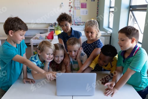 Preview: Group of schoolchildren using a laptop computer in an elementary school classroom