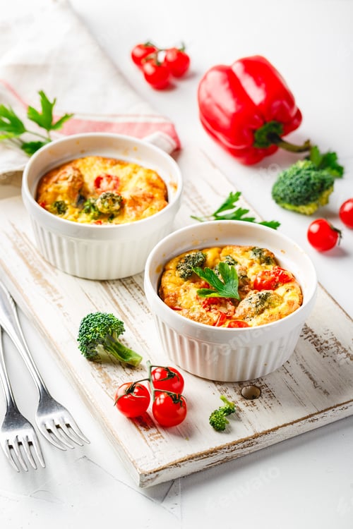 Preview: Vegetable frittata with broccoli, red bell pepper and red onion in cast iron skillet.
