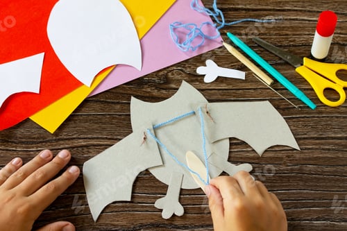 Preview: The child draws the details of dracola bat toy Halloween.