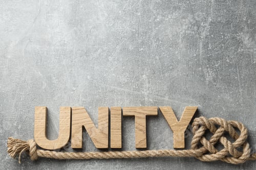 Preview: The word "unity" in wooden letters with a rope. Place for text