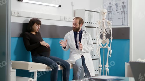 Preview: Male doctor and woman with pregnancy belly doing medical consultation