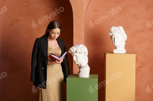 Preview: Portrait of thoughtful concentrated busy charming woman with notebook in her