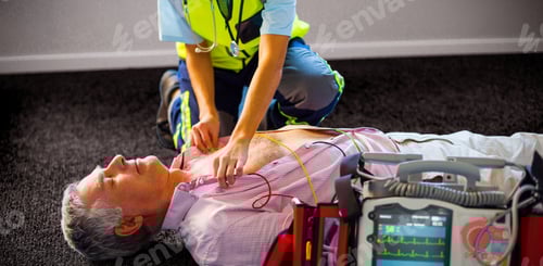 Preview: Paramedic using an external defibrillator on an unconscious patient