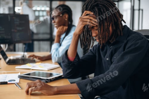 Preview: Man is tired, exhausted. Business people are working in the office
