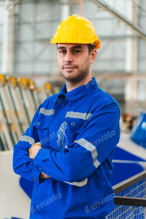 Preview: paper cardboard manufacture factory concept, industry worker person working with recycling machine