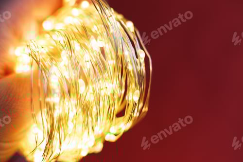 Preview: christmas beautifull shiny gold garland on a red background. sparkle festive background