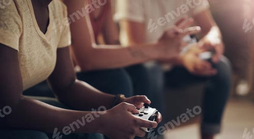 Preview: Im going to kick your butt at this game. Shot of a group of friends playing console games at home.