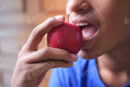 Preview: child boy eating apple close up
