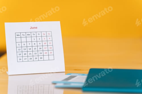 Preview: Tickets in the passport next to the June calendar against yellow background