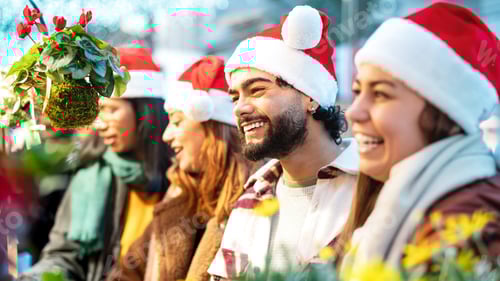 Preview: Happy friends having fun shopping at Christmas market on winter time