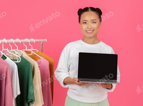Preview: Online Sales. Asian Shopaholic Woman Holding Laptop With Blank Black Screen,