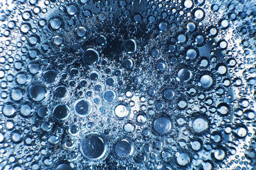 Preview: abstract light blue background with oil circles . bubbles of water close up